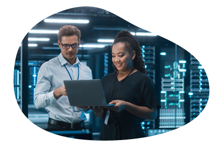 Two employees at a cloud computing company working on a laptop. Two employees at a cloud computing company working on a laptop.