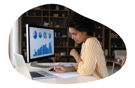 Data analyst examining trends on a computer. Data analyst examining trends on a computer.