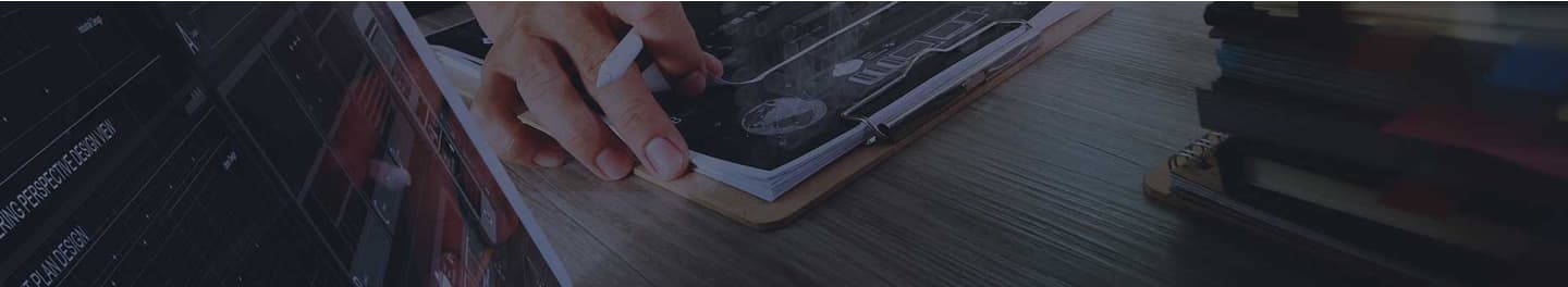Data scientist at desk with a clipboard full of papers.