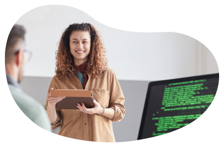 An education tech consultant reviewing software code with a programmer.