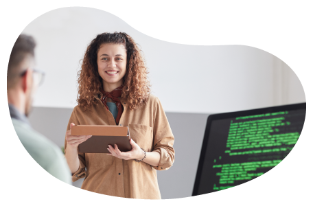 An education tech consultant reviewing software code with a programmer. An education tech consultant reviewing software code with a programmer.