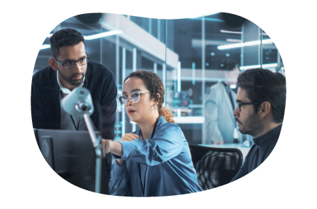 An IT trainer providing instruction to a client and their employee