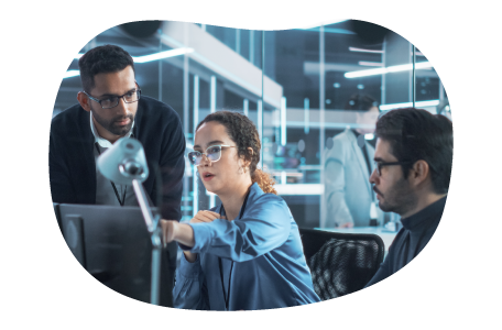 An IT trainer providing instruction to a client and their employee An IT trainer providing instruction to a client and their employee