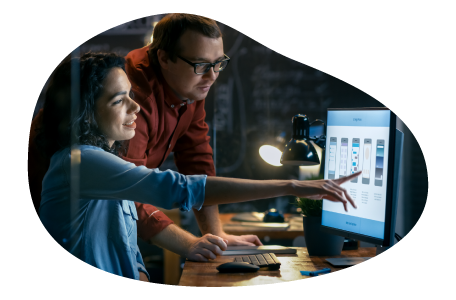 Two employees for a managed service provider (MSP) collaborate on a project. Two employees for a managed service provider (MSP) collaborate on a project.