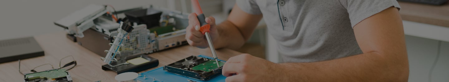 An employee works on a PC with a soldering iron. An employee works on a PC with a soldering iron.