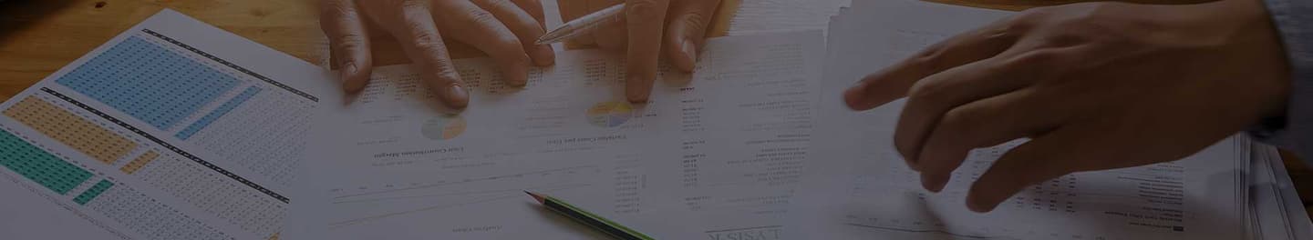 SEO and SEM consultants huddled around a desk looking at data.