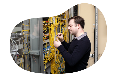 Telecommunications consultant examining wiring at a client facility.