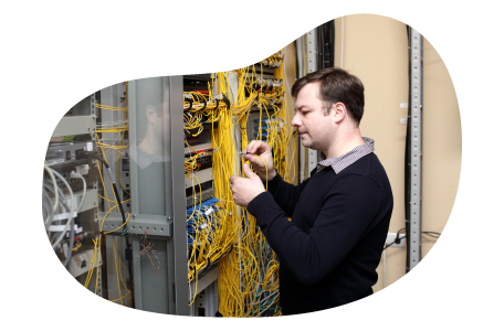 Telecommunications consultant examining wiring at a client facility. Telecommunications consultant examining wiring at a client facility.
