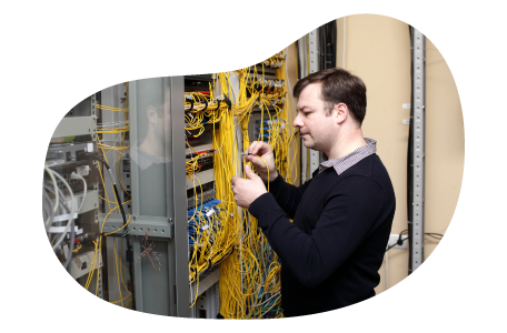 Telecommunications consultant examining wiring at a client facility.