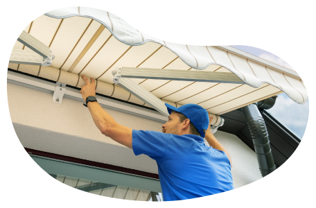 A contractor installs an awning on a customer's home.