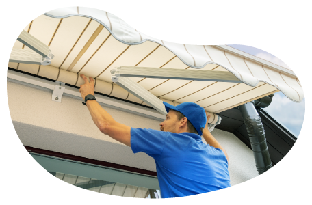 A contractor installs an awning on a customer's home. A contractor installs an awning on a customer's home.