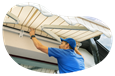 A contractor installs an awning on a customer's home.