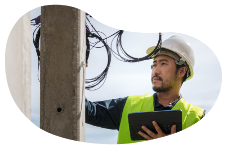 A cable installer working on a utility pole.