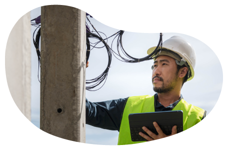A cable installer working on a utility pole. A cable installer working on a utility pole.