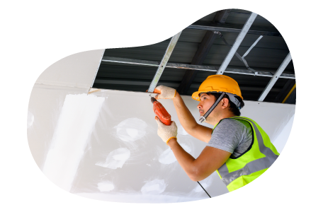 Contractor installing ceiling tiles in a building.