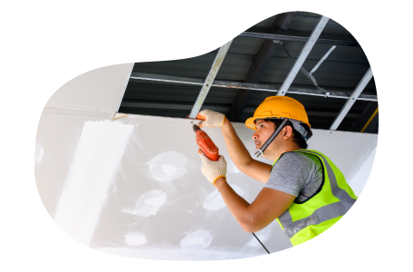 Contractor installing ceiling tiles in a building. Contractor installing ceiling tiles in a building.