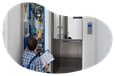 A technician configures the controls on a newly installed elevator.