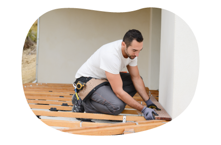 Contractor installing floorboards in a home.
