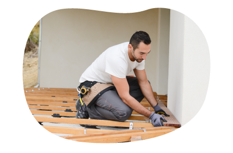 Contractor installing floorboards in a home. Contractor installing floorboards in a home.