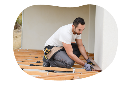 Contractor installing floorboards in a home.