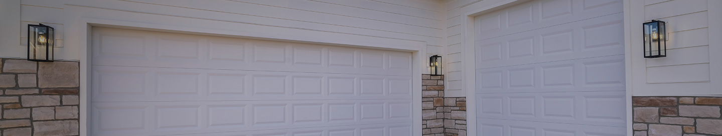 Newly installed garage doors at a residence. Newly installed garage doors at a residence.