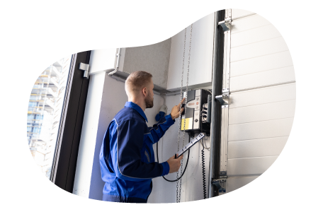 A contractor installs a garage door unit.