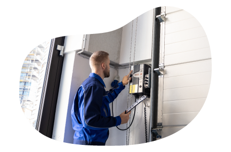 A contractor installs a garage door unit. A contractor installs a garage door unit.