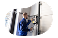 A contractor installs a garage door unit.