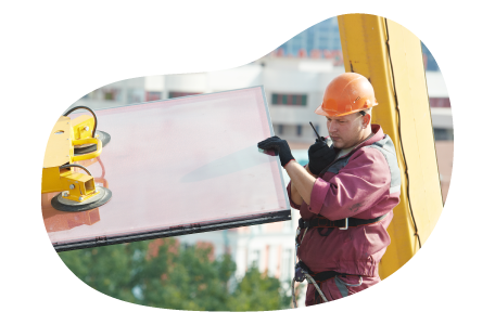 Contractor moving glass for installation in a building.