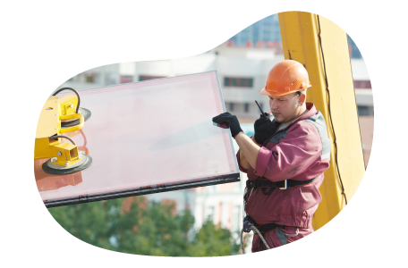 Contractor moving glass for installation in a building. Contractor moving glass for installation in a building.