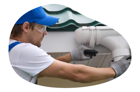 A contractor installs a new gutter on a home.