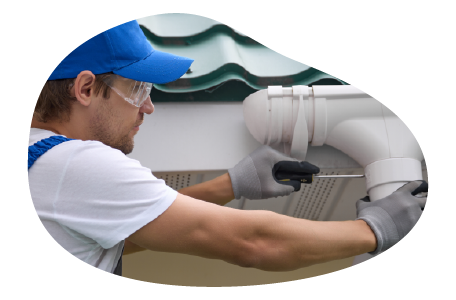 A contractor installs a new gutter on a home. A contractor installs a new gutter on a home.