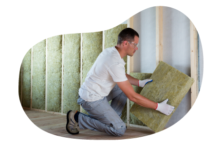 A contractor installs wall insulation in a client's home. A contractor installs wall insulation in a client's home.