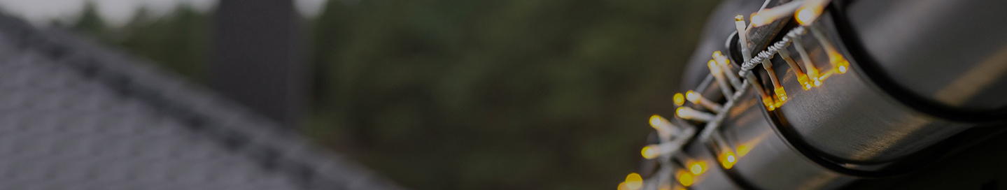 A string of holiday lights on a home.