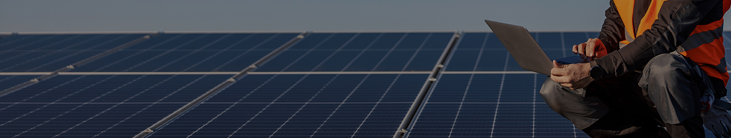 A contractor checks that newly installed solar panels are working.