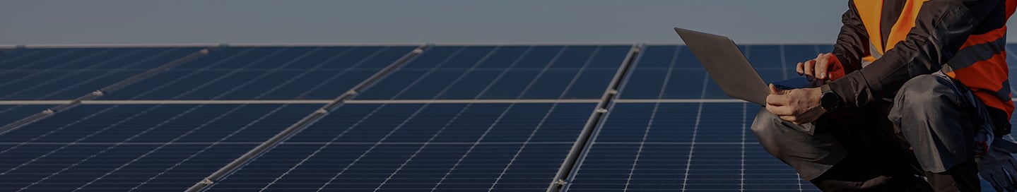 A contractor checks that newly installed solar panels are working. A contractor checks that newly installed solar panels are working.