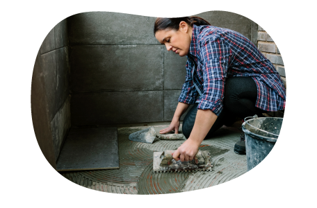 Contractor installing stone tiles in a building. Contractor installing stone tiles in a building.