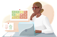 Actuary working at laptop in front of charts.