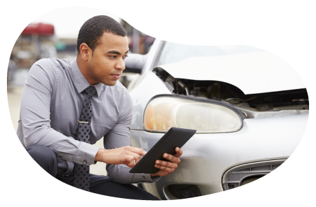 Insurance claims adjuster evaluating vehicle damage.