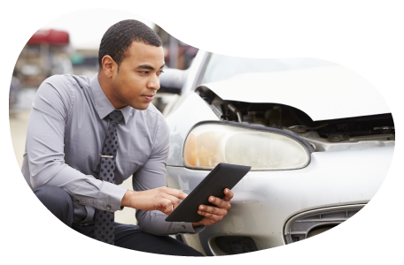Insurance claims adjuster evaluating vehicle damage. Insurance claims adjuster evaluating vehicle damage.