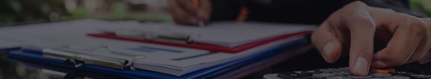 Insurance agent punching numbers into a calculator.