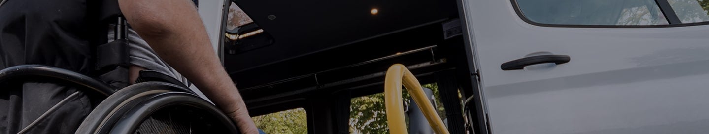 A person in a wheelchair getting into an accessible van. A person in a wheelchair getting into an accessible van.