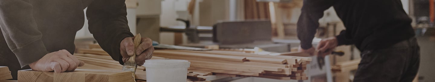 Employees working at a cabinet manufacturing business. Employees working at a cabinet manufacturing business.