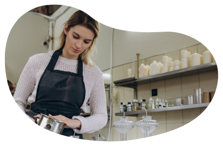 A candle maker working in a shop.