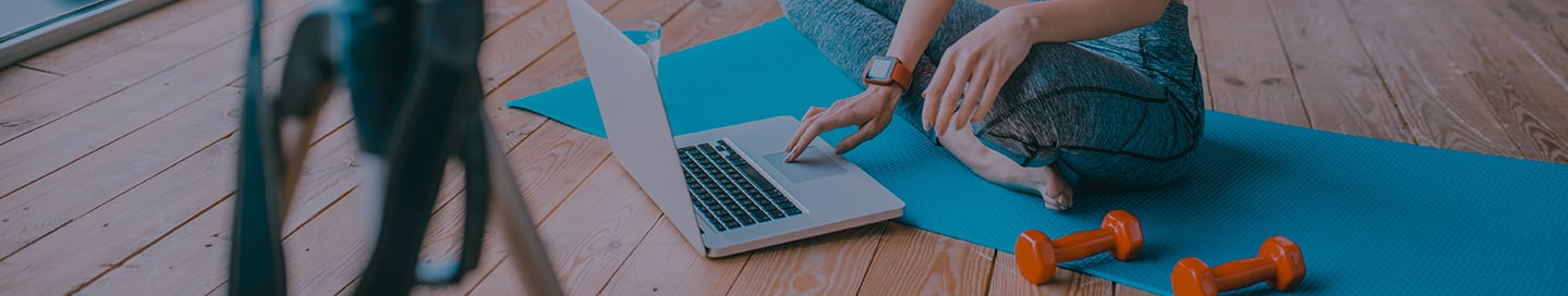 A blogger sitting on a yoga mat and typing on a laptop. A blogger sitting on a yoga mat and typing on a laptop.