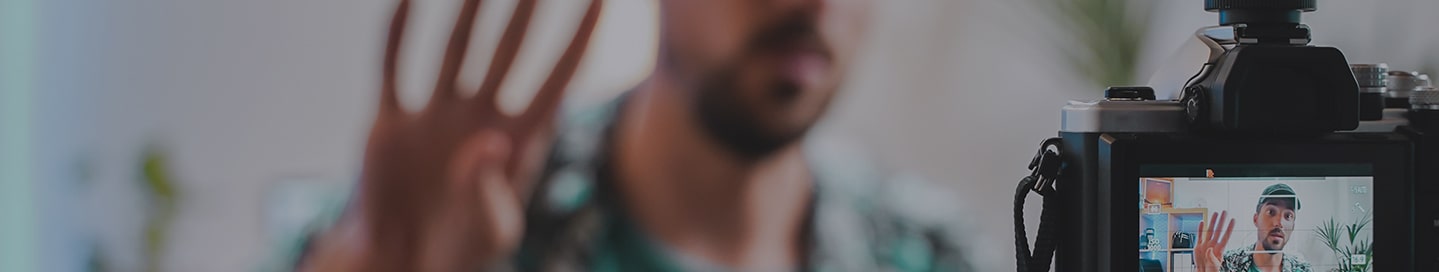 A social media influencer recording a video of themselves.