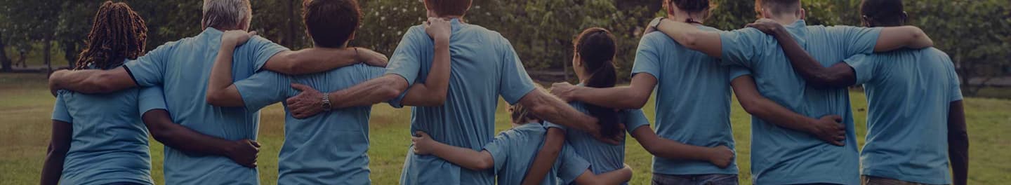 Group of people with arms linked walking away.