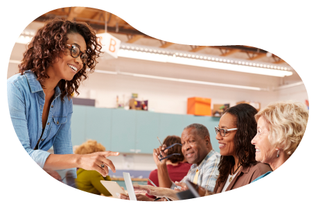 Community center employee working with visitors at an event. Community center employee working with visitors at an event.