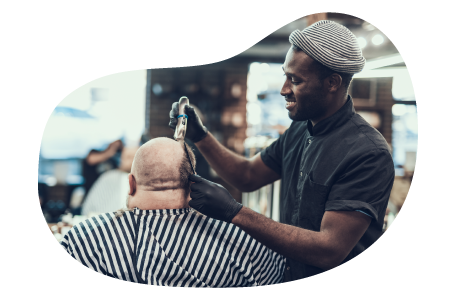 Barber styling a client's hair.
