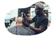 Barber styling a client's hair.